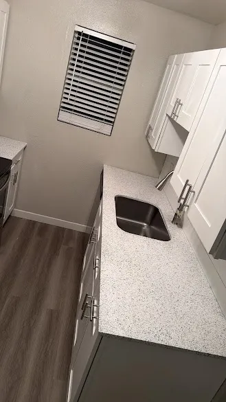 Kitchen with freshly painted white shaker cabinets and a granite countertop in Phoenix