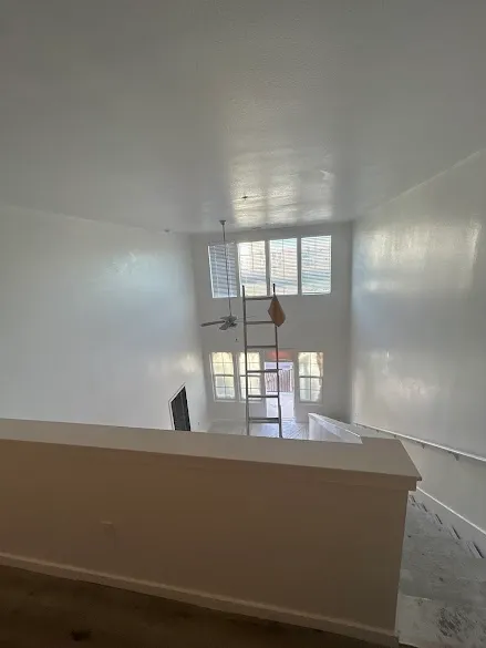 Freshly painted two-story interior walls and ceiling in a Phoenix home, seen from the upstairs landing